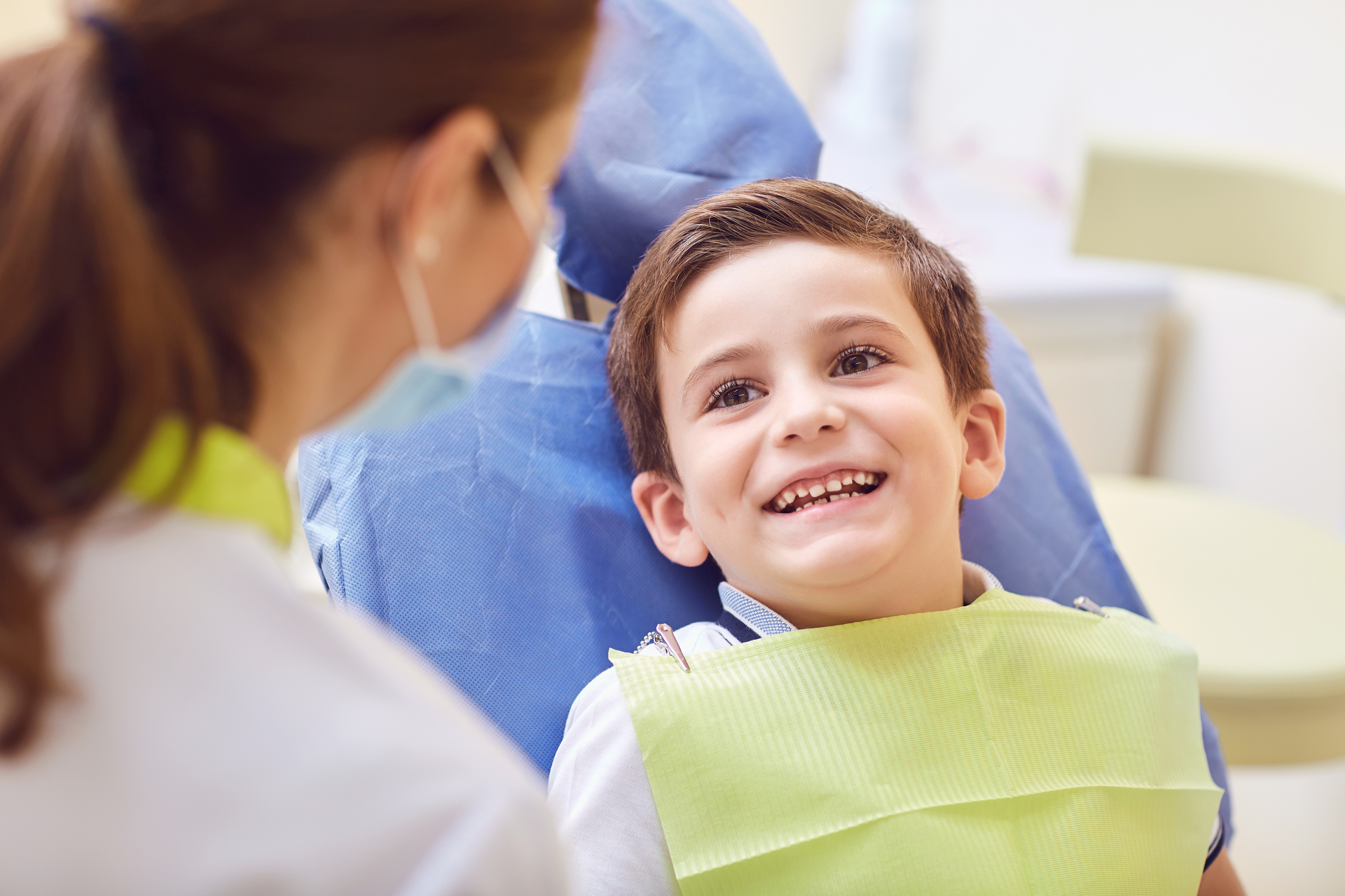 A child with a dentist in a dental office